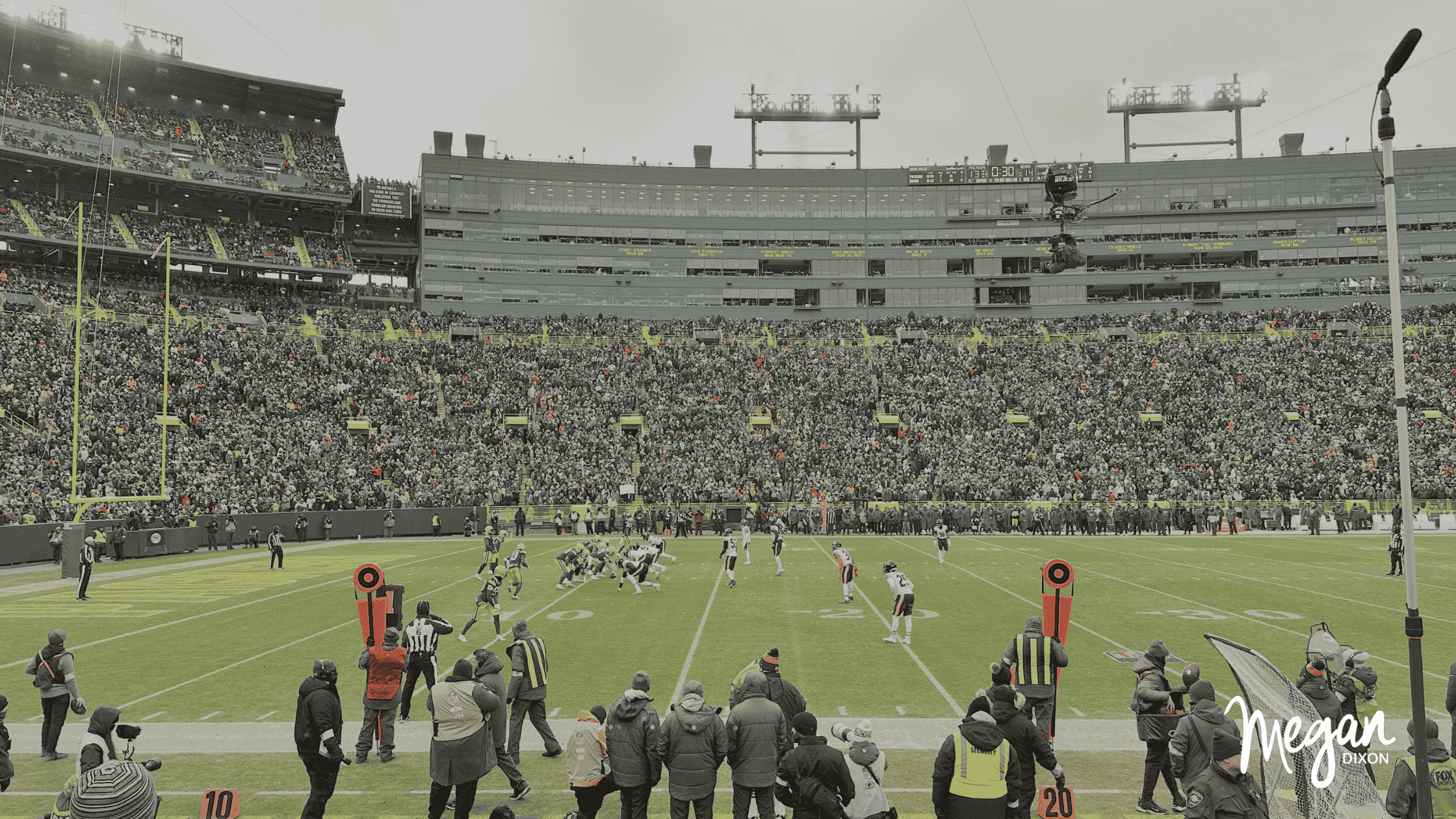 Megan Dixon in Packers gear at Lambeau Field, smiling and relaxed, symbolizing freedom from hustle.